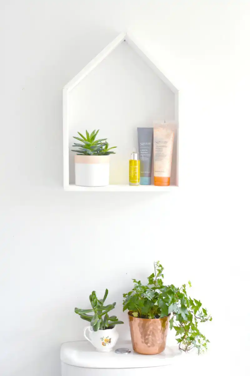 A shaped house shelf for nursery room organization storage