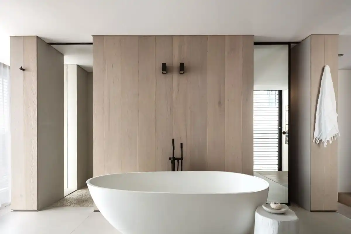A soaking tub takes center stage in the large and open bathroom.