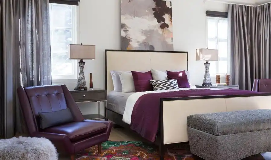 Accent colors bedroom with bed placed between windows