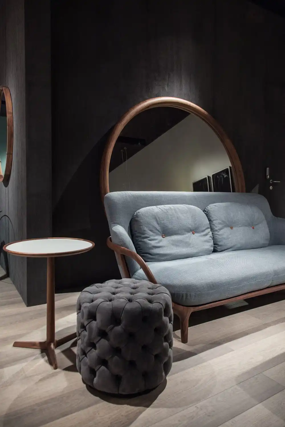 Add a round mirror behind the sofa for a dramatic look
