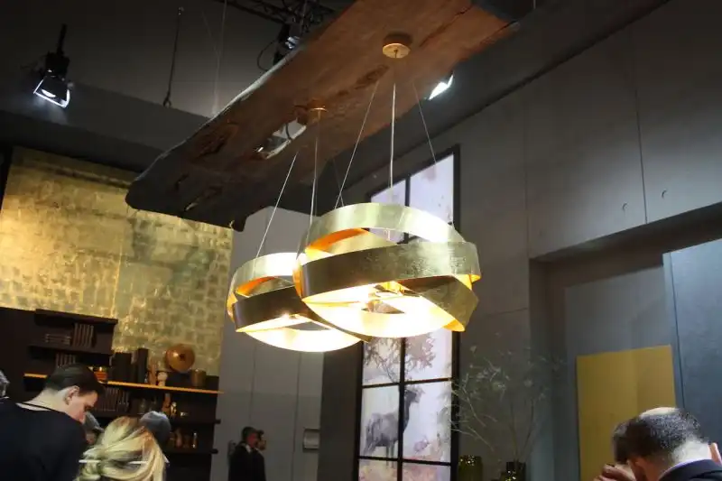 The gleaming metal of the fixture is offset by the live edge base, an interesting addition to the otherwise modern kitchen design.