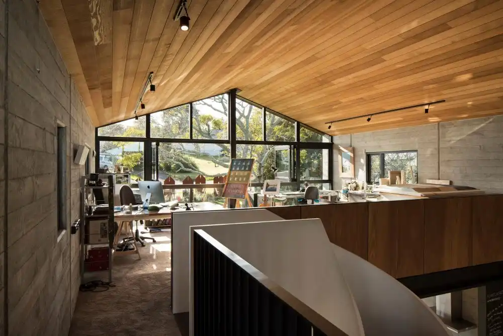 The mezzanine floor frames the central double-height space and houses a studio on one side