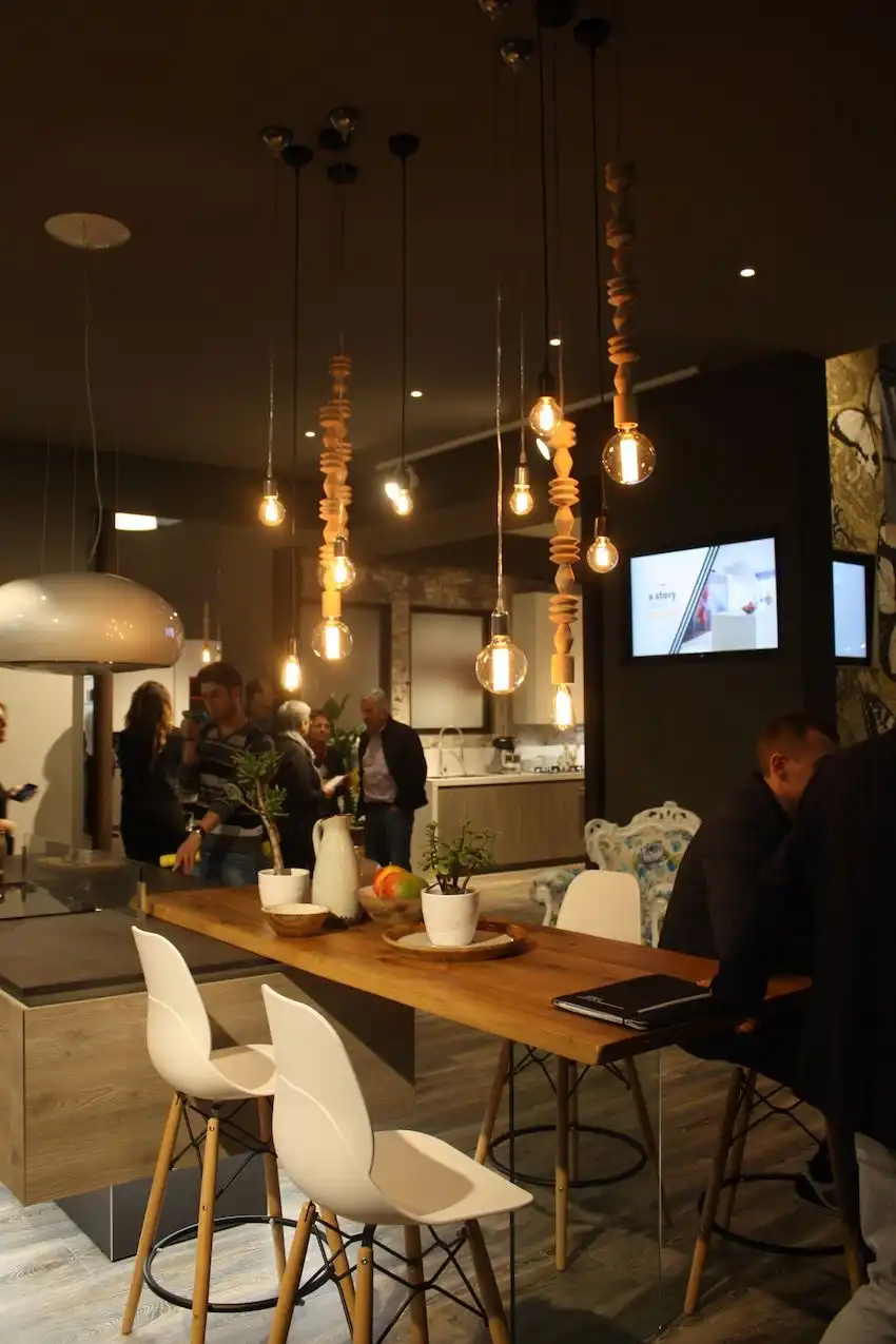Arrex displayed this cool arrangement of pendants as a kitchen lighting scheme for a dining table. The mix of long wood spindles, combined with the modern clear, exposed bulb fixtures, creates a fixture that is also a conversation piece.