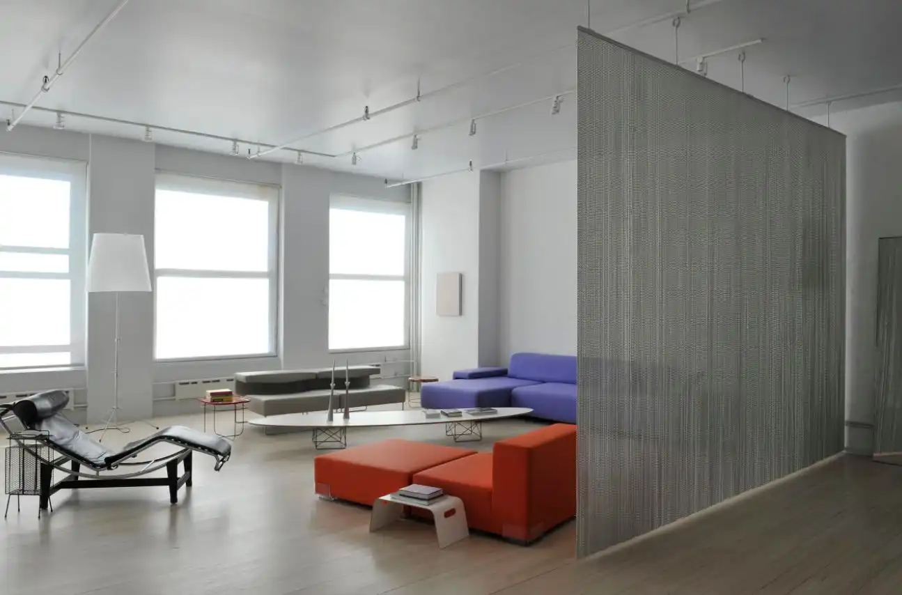 Artist loft room divider through a metalic curtain