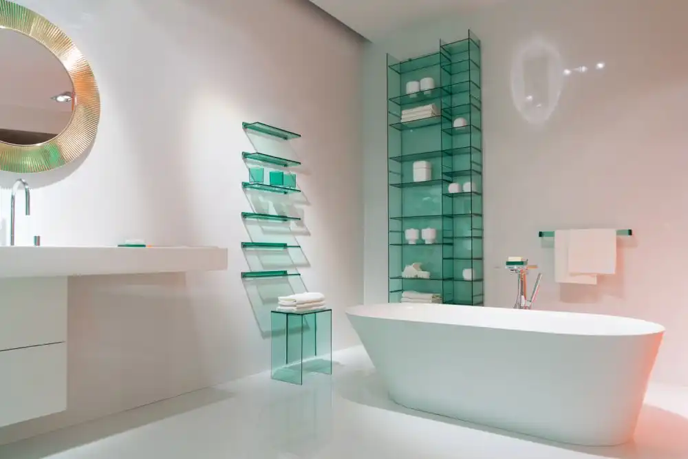 Bathroom featuring glass shelves and curved bathtub lines