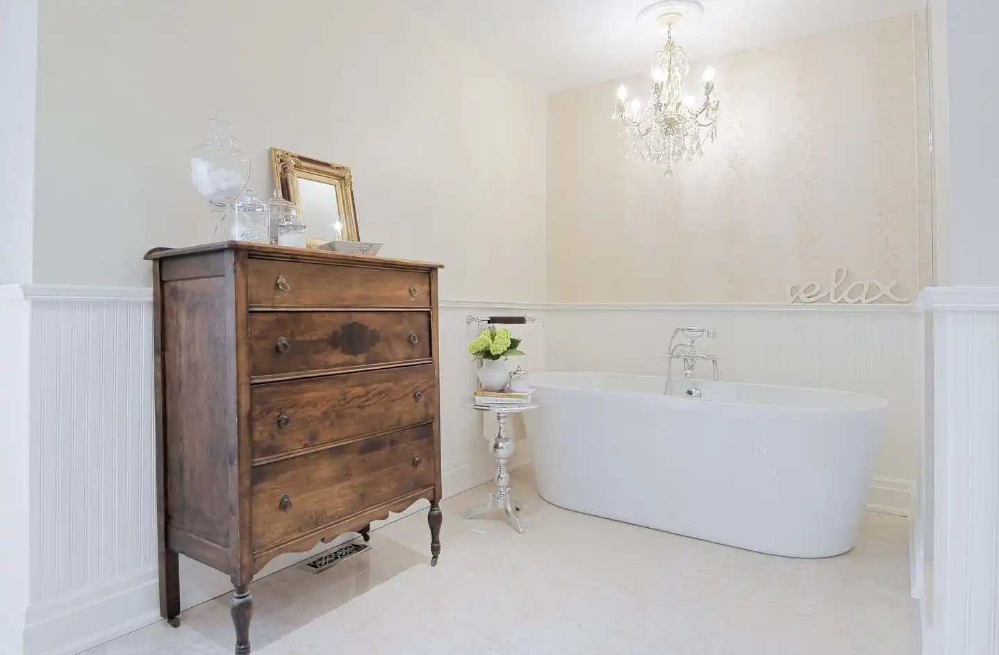 Bathroom with white beadboard and vintage dresser