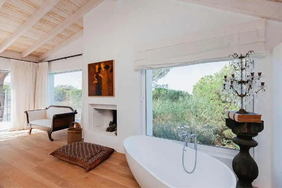 Bathroom with wooden floor and large window -curved Bathtub