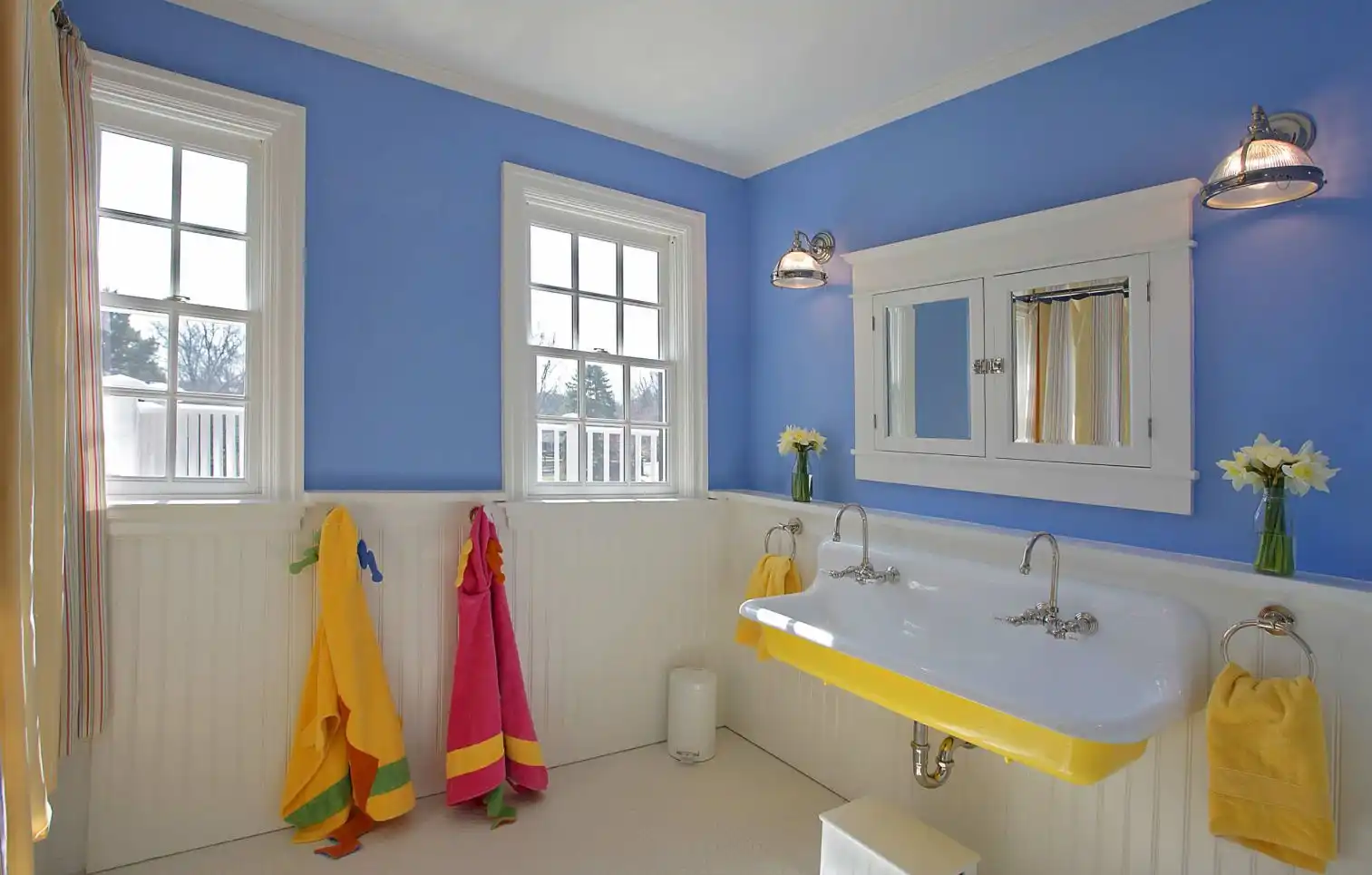 Bathroom with yellow accent through accessories and white beadboard