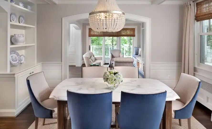 Beautiful dining room with marble table and beaded chandelier above