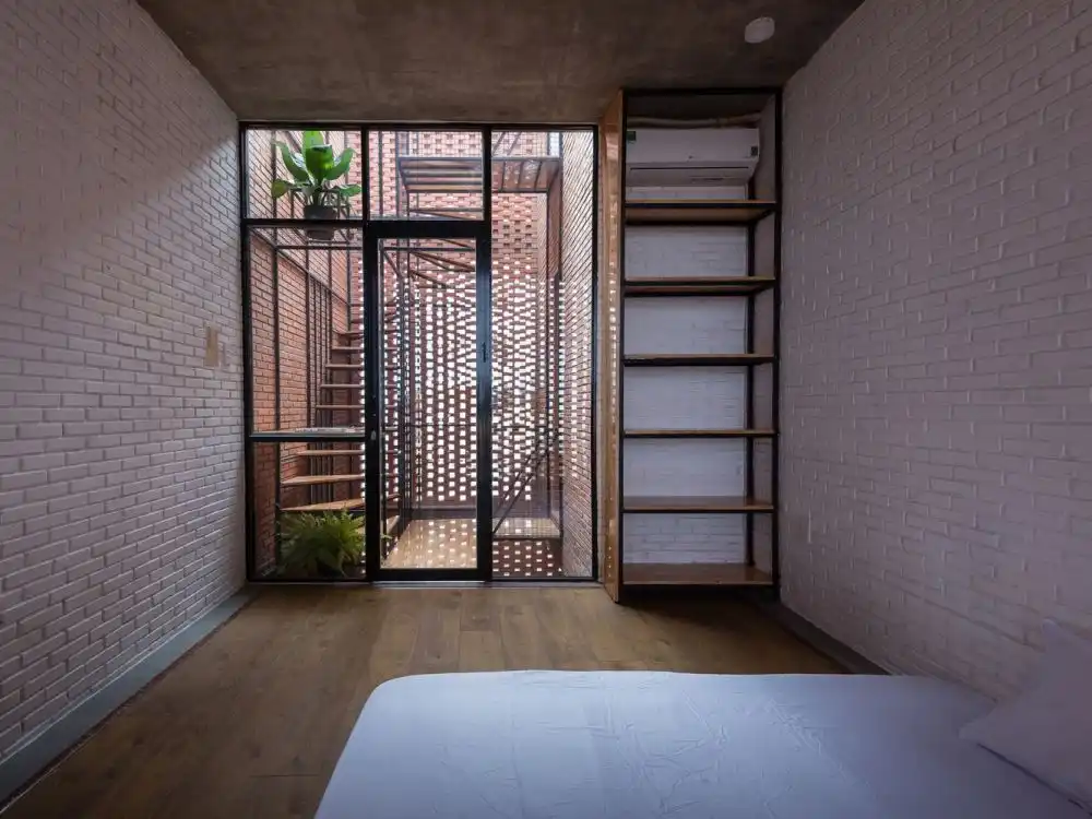 Bedroom with natural light from perforated facade