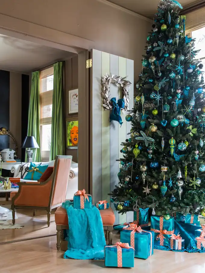 Big christmas tree with turoise accents and gifts wrapperd