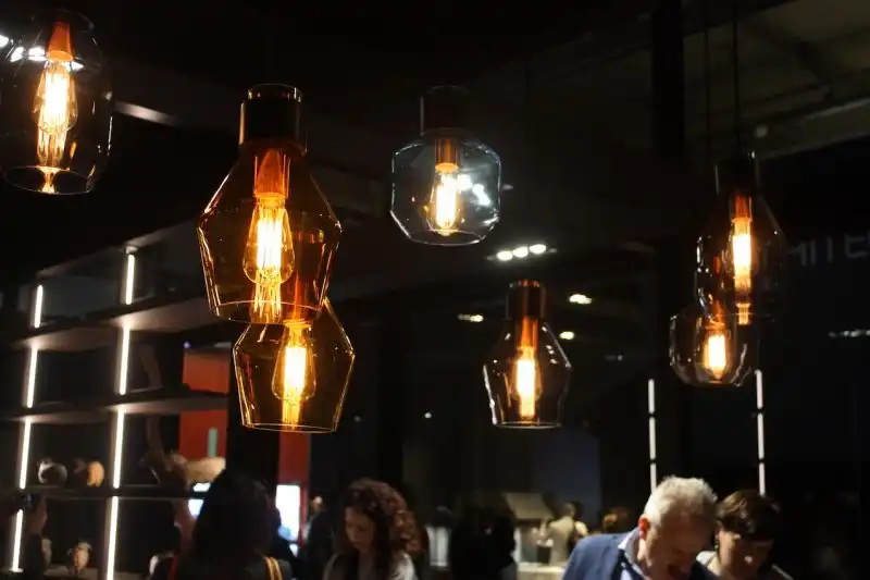 The same mixed and staggered arrangement works with these kitchen lighting pendants in the Binova exhibit. The tinted blown glass gives off a very soft and cozy light.