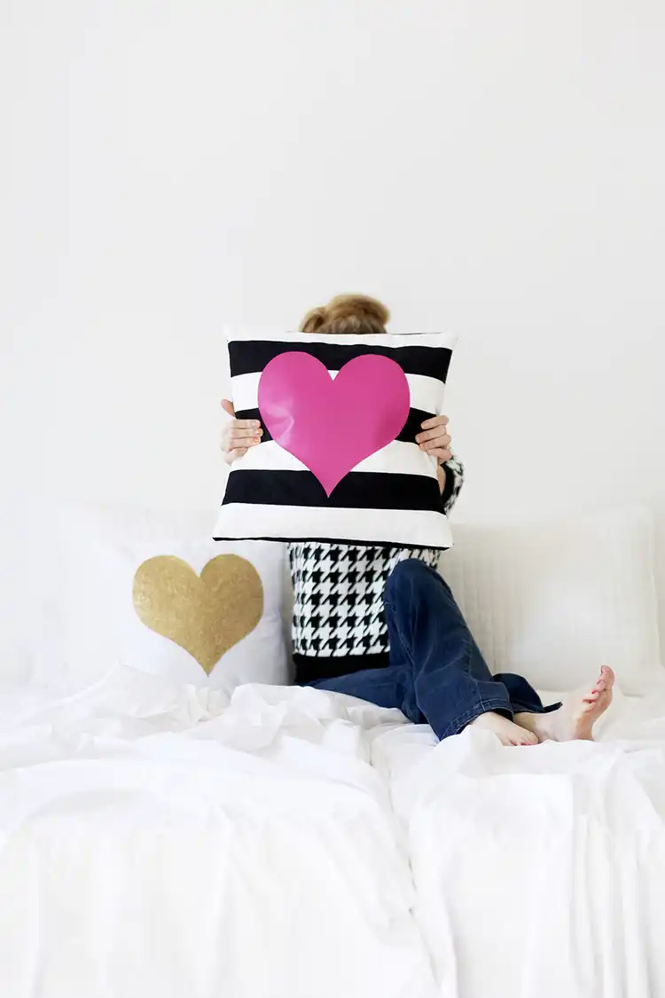 Black and white striped pillow with a pink heart