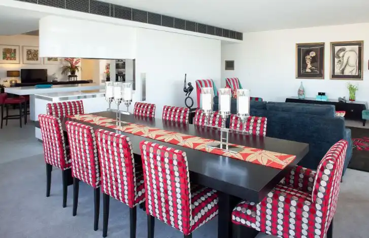 Black dining table with red armchairs