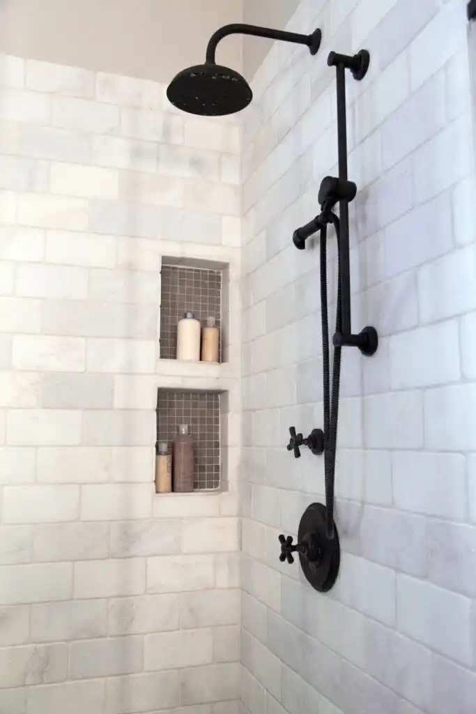 Black shower fixture and marble tiles 683x1024