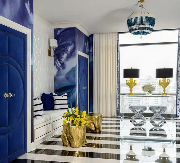 Blue decor hallway featuring gold stumps and beaded chandelier