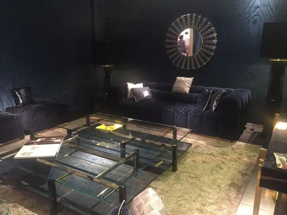Blue living room design with large sofa and a small mirror on the wall