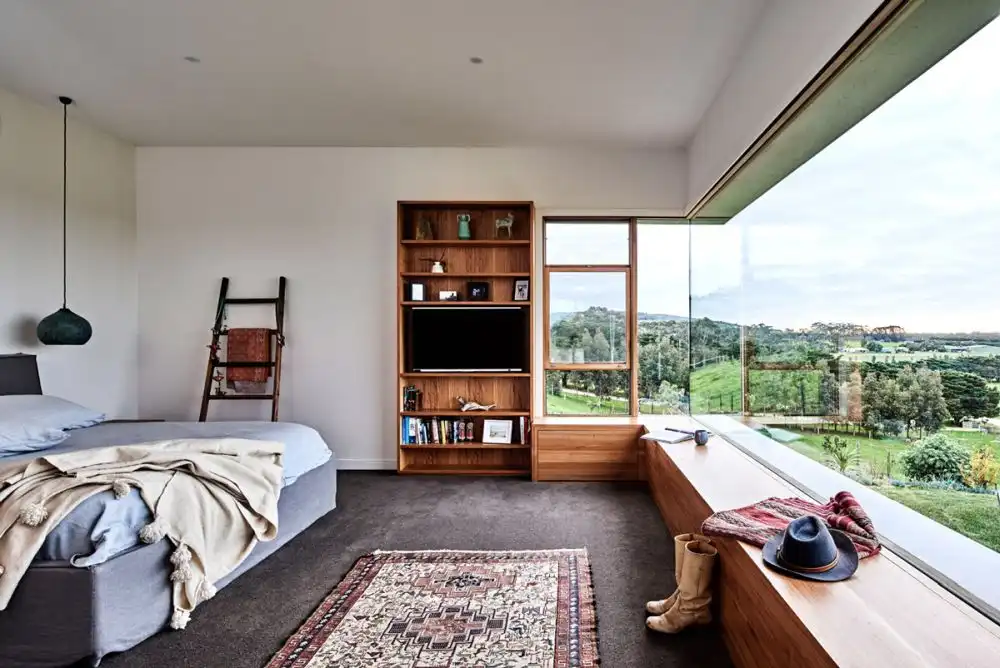 Bohemian bedroom with large corner window