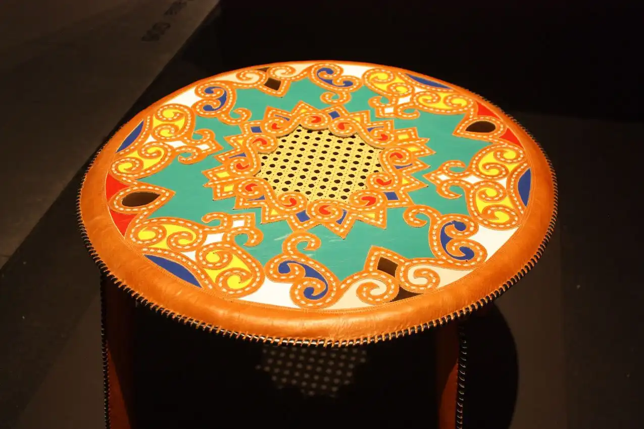 This table is an excellent example of the colors and masterful craftsmanship of the leatherwork in the collection. The stunning detail in this table would be a conversation piece in any setting.