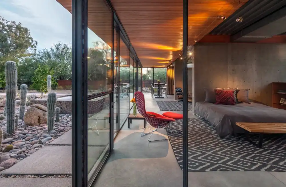 The combination of exposed concrete and wood is well-balanced and suits the internal spaces quite nicely