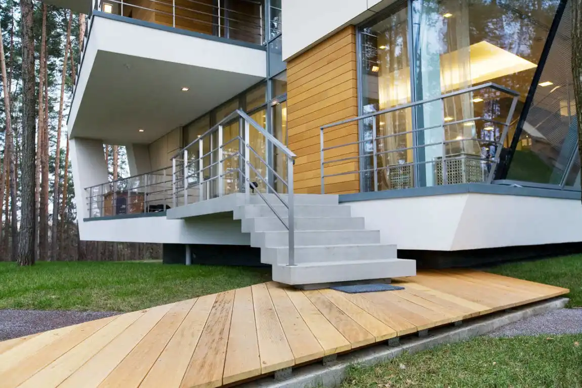 Contemporary house with wood deck and metallic balustrade for stair