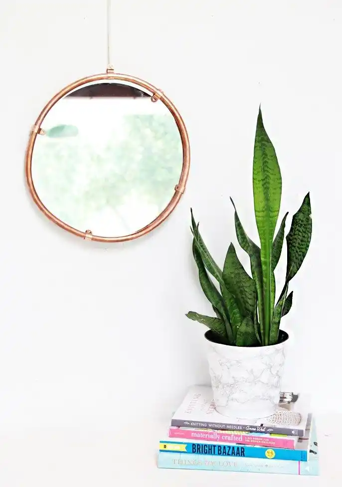 Bend a copper pipe into a frame for your mirror