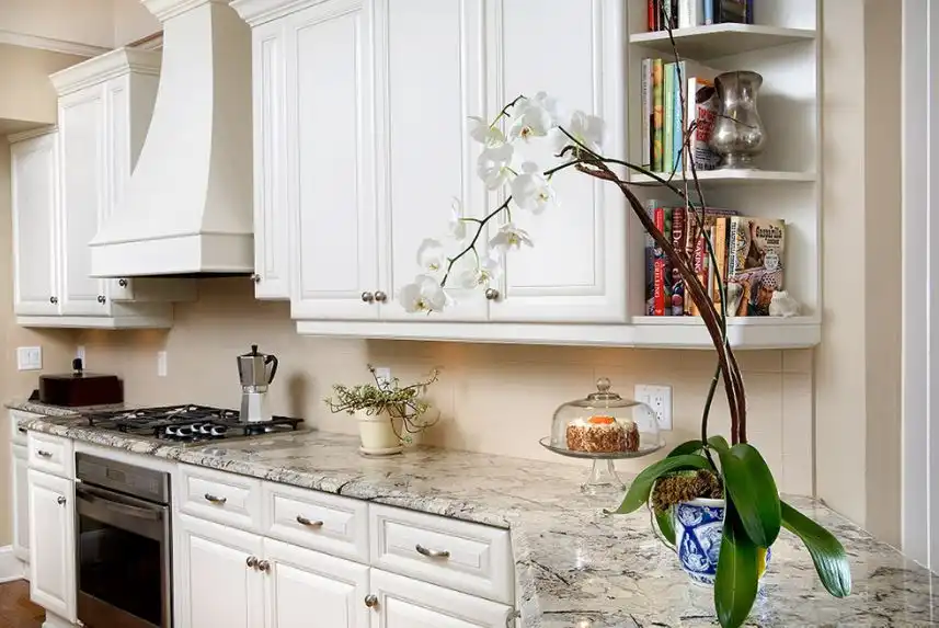 Corner shaped granite countertop for white kitchen cabinets