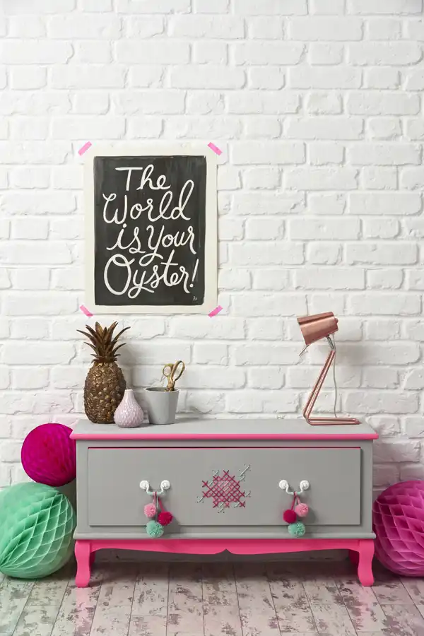 up cycled chest of drawers against white brick wall