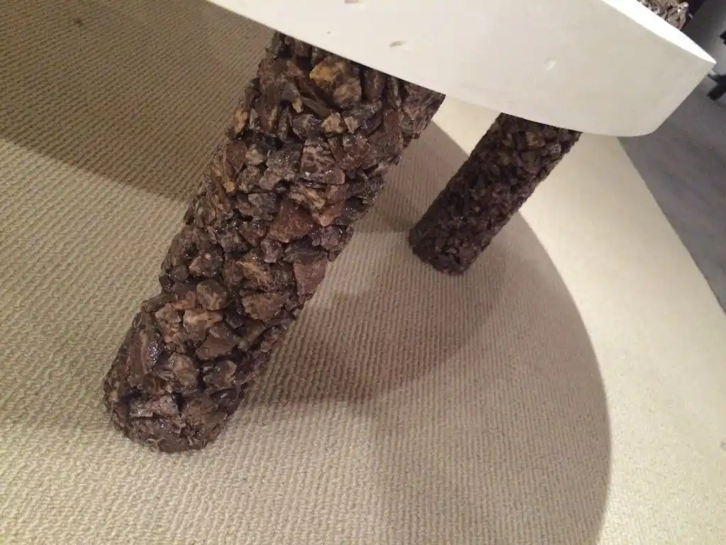 The stone coating give the coffee table legs added interest and heft.