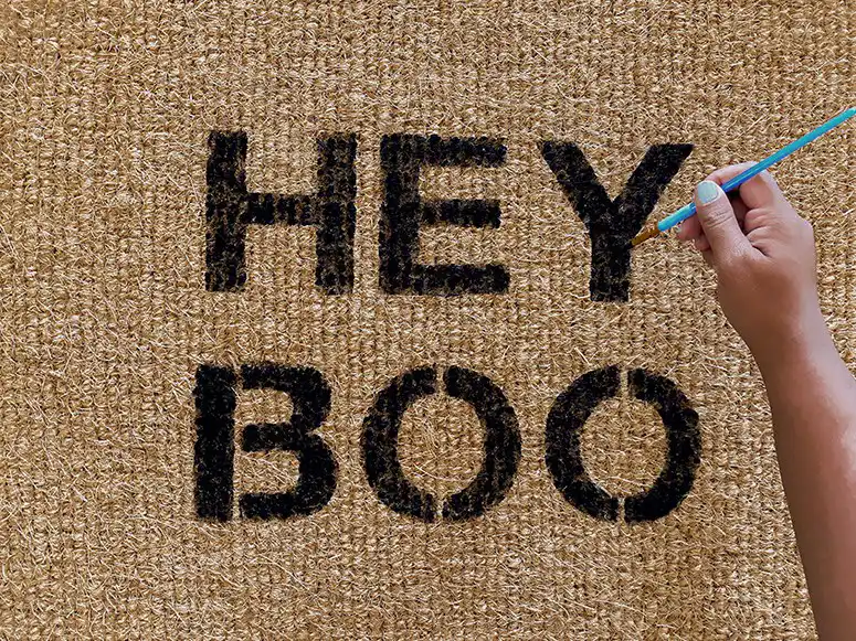 Custom doormat using letter stencils