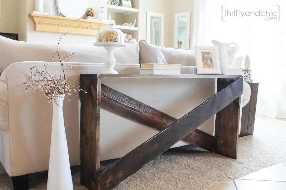 Cute x shaped narrow table behind sofa