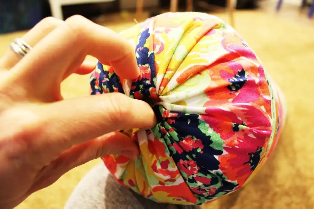 DIY Sew a Bolster Pillow Use your finger to poke the fabric edges