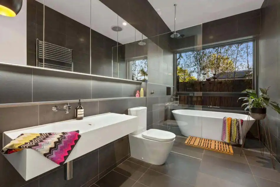 Dark bathroom design with freestanding tub