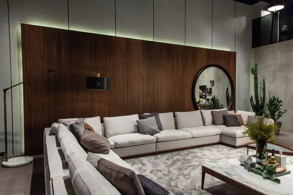 Decorating a living room with large round mirror on a paneled wall