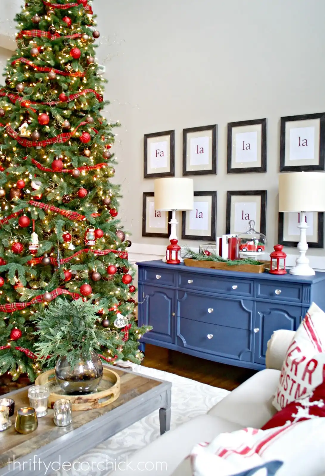 Decorating the Christmas Tree with Red globes and garland