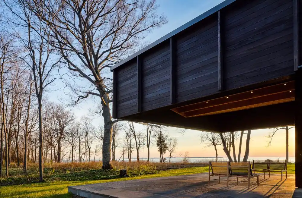 The covered outdoor terrace is the perfect viewing spot from where to admire the lake