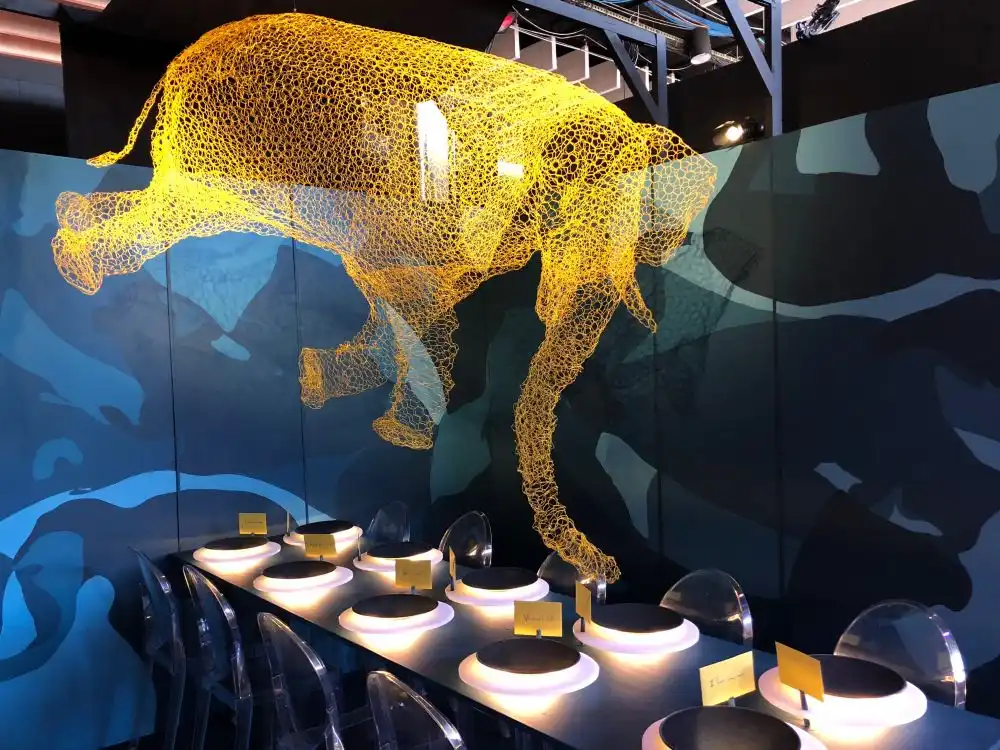 Dining table with an oversized elephant lighting fixture