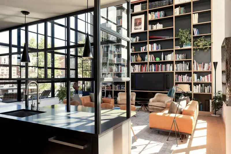 Double height the living room with floor to ceiling bookcases