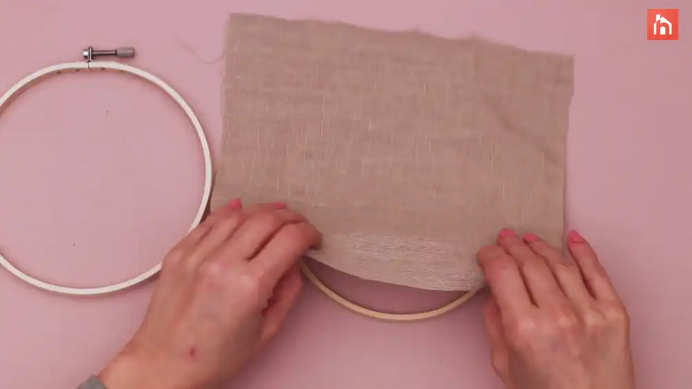 Secure the fabric between the two hoops