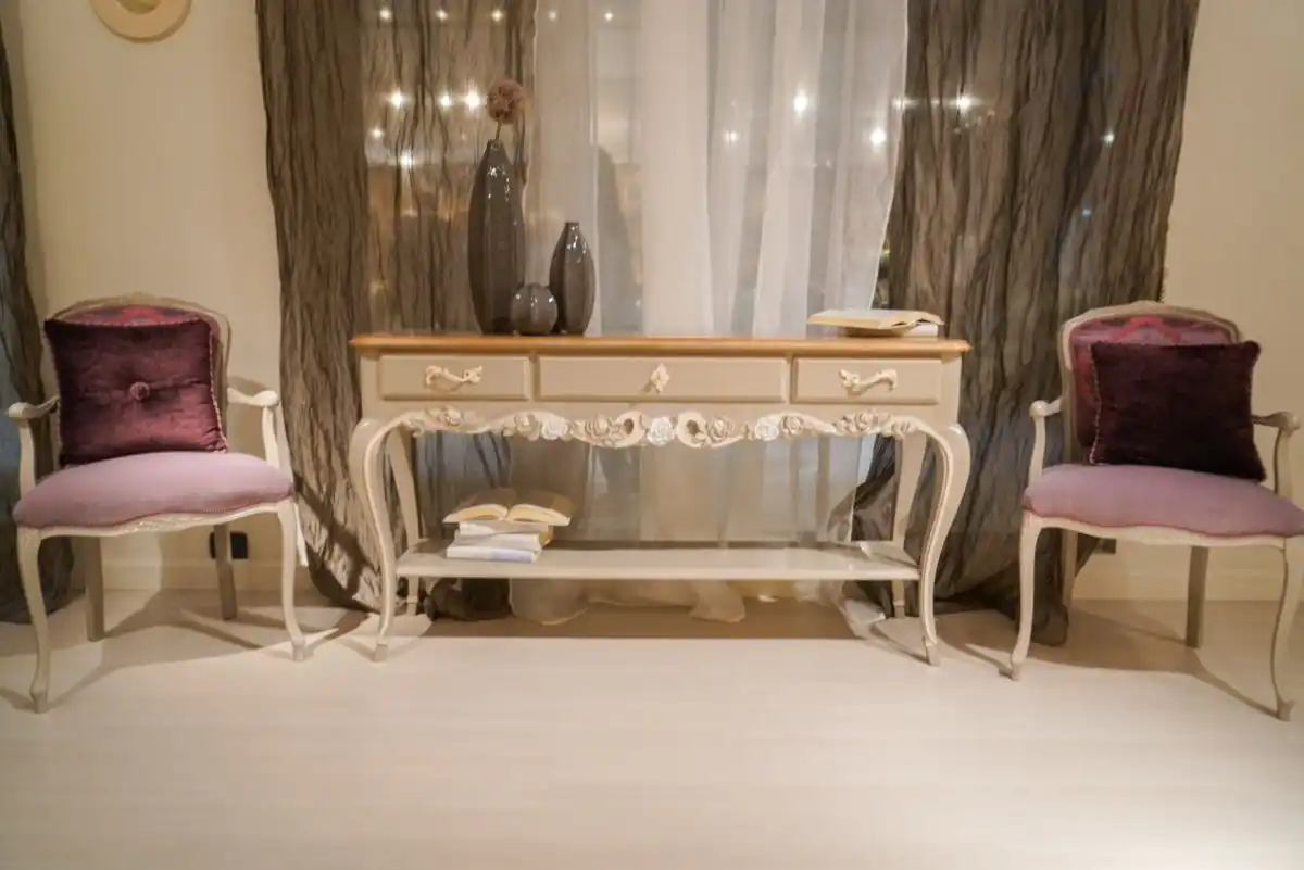 Entryway with velvet pink upholstered chairs and small console table with drawers