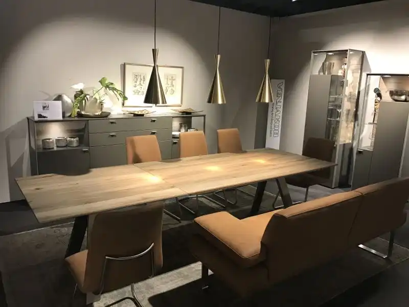 Expandable dining table with leather brown bench sofa and chairs copper pendant lights over
