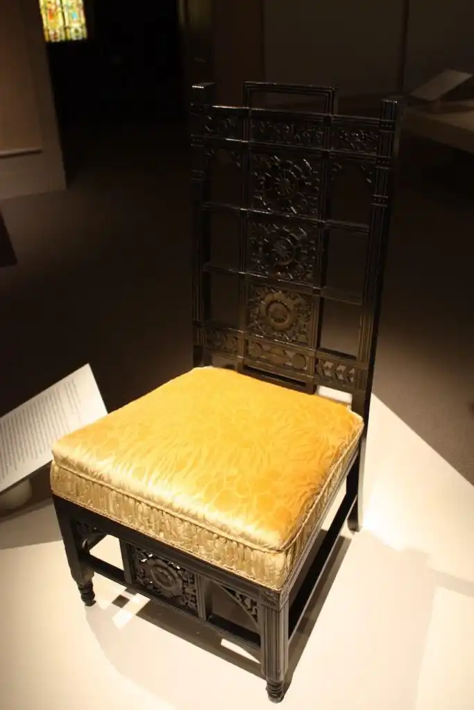 This chair does not have an upholstered back, but the seat could accommodate the era's fashionable skirts.