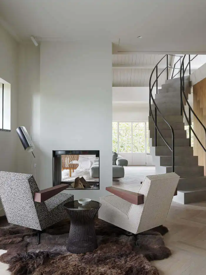 Fireplace between two rooms and interior staircase