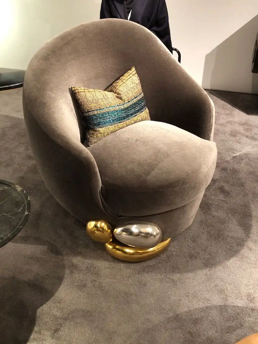 An asymmetrical metal accent piece adds to this chair's distictiveness.