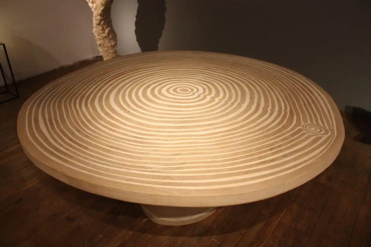 The table design even features a "knothole" detail like that you would find in a board.