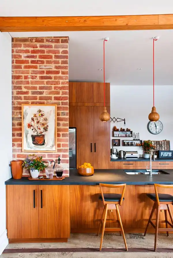Gallery kitchen with exposed bricks