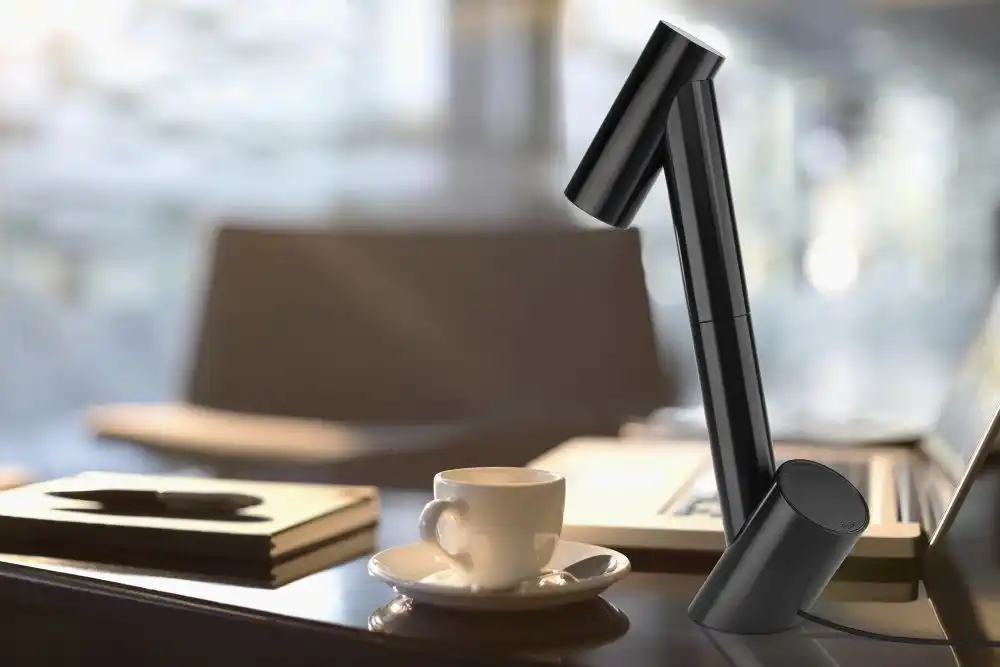 Coffee cup, laptop, notebook and pen in office