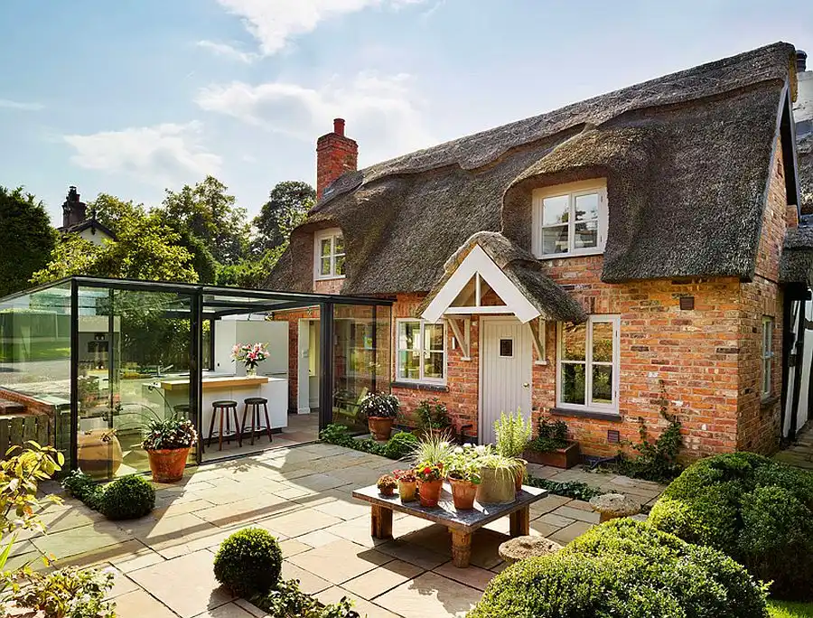 Glass box extension for an English cottage house