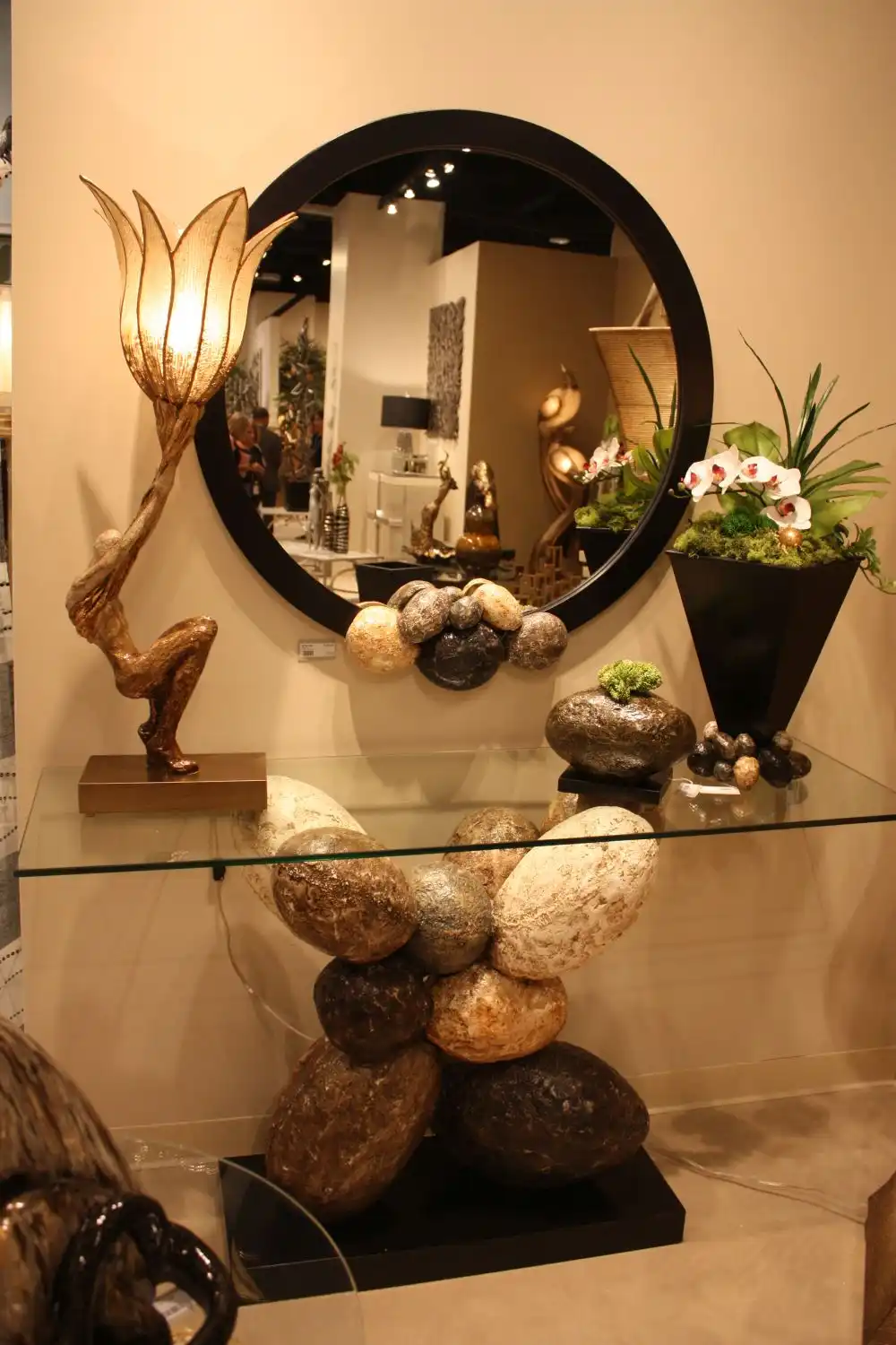 Glass top console with an interesting base and round mirror