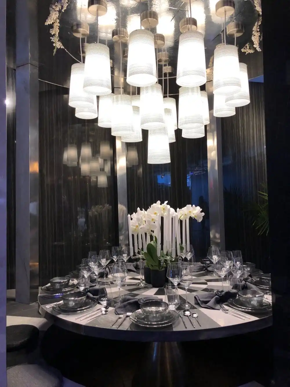 Gray dining tabel centerpiece with large pendant light
